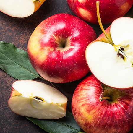 Fresh Red Appels cut on a wood surface